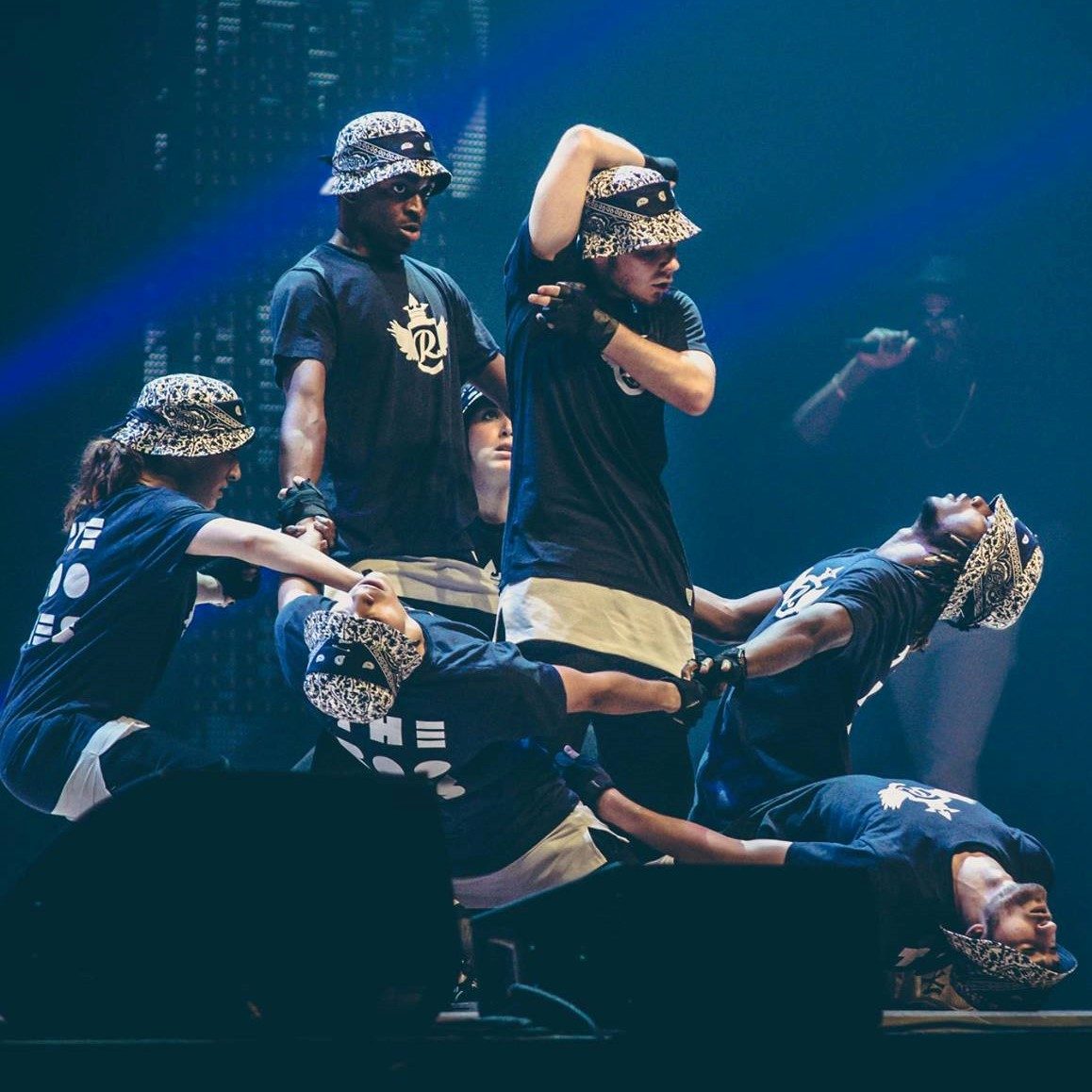 Des danseurs exécutant une chorégraphie dynamique sur scène.